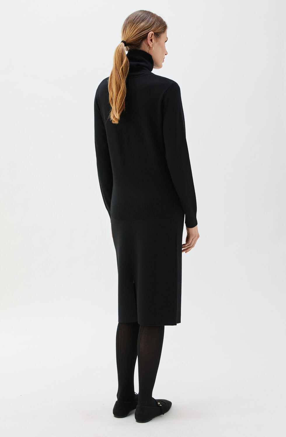 Woman wearing a black dress on a white background