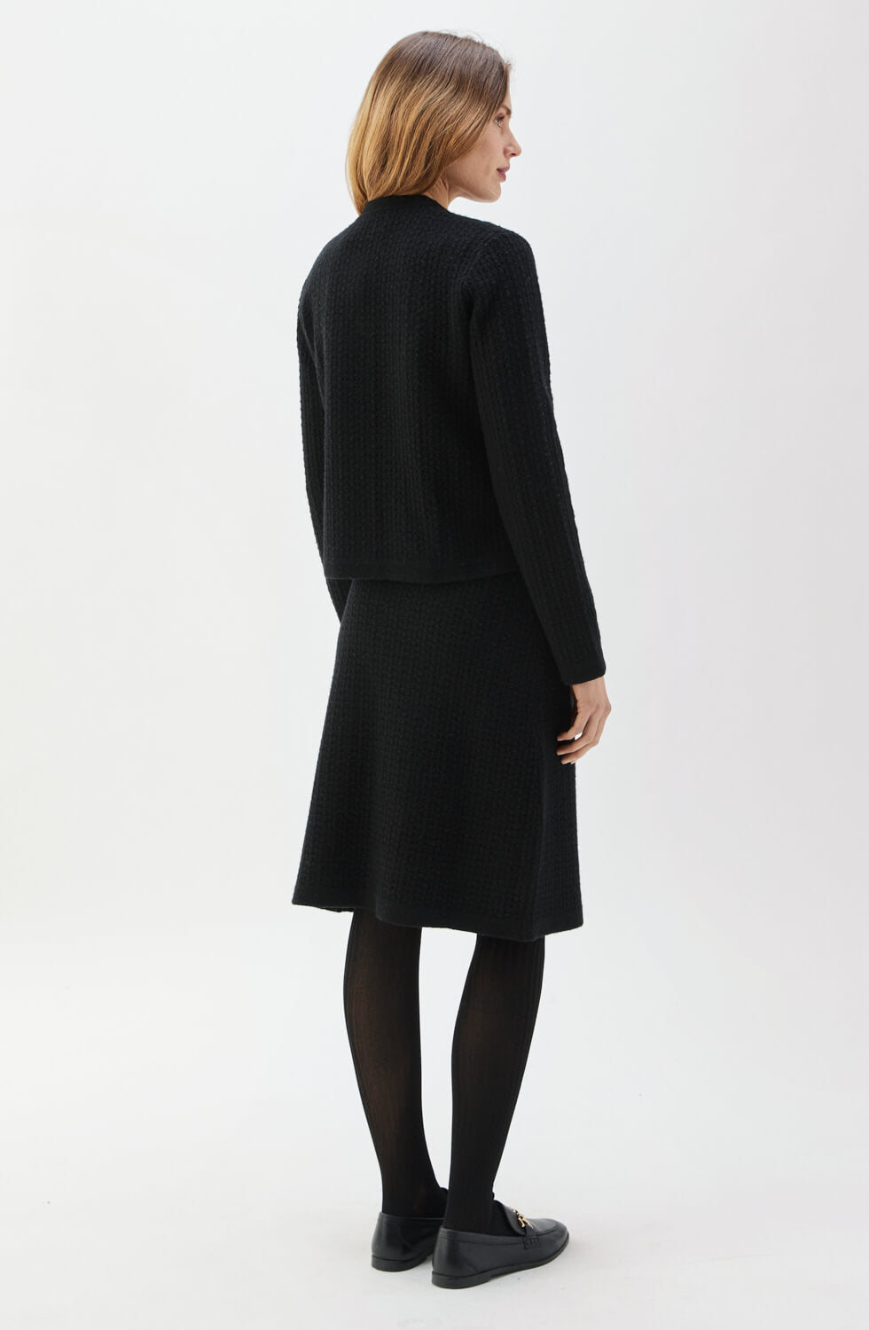 Woman wearing a black outfit on a white background